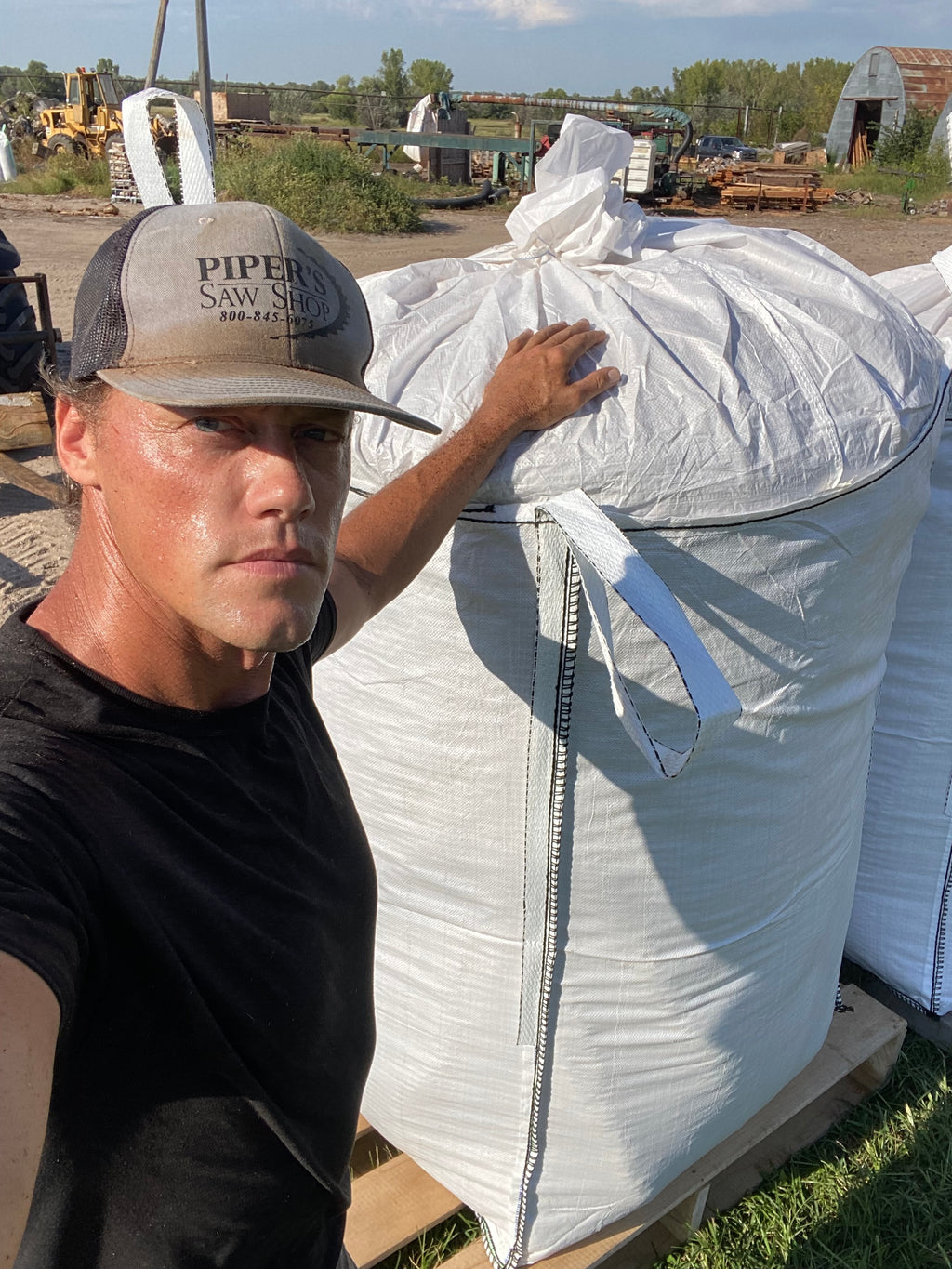 The Cedar Baron standing in front of Cedar Barons Show Fiber Bulk Bag 